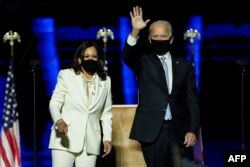 U.S. President-elect Joe Biden and Vice President-elect Kamala Harris achnowledge supporters after delivering remarks in Wilmington, Delaware, Nov. 7, 2020.