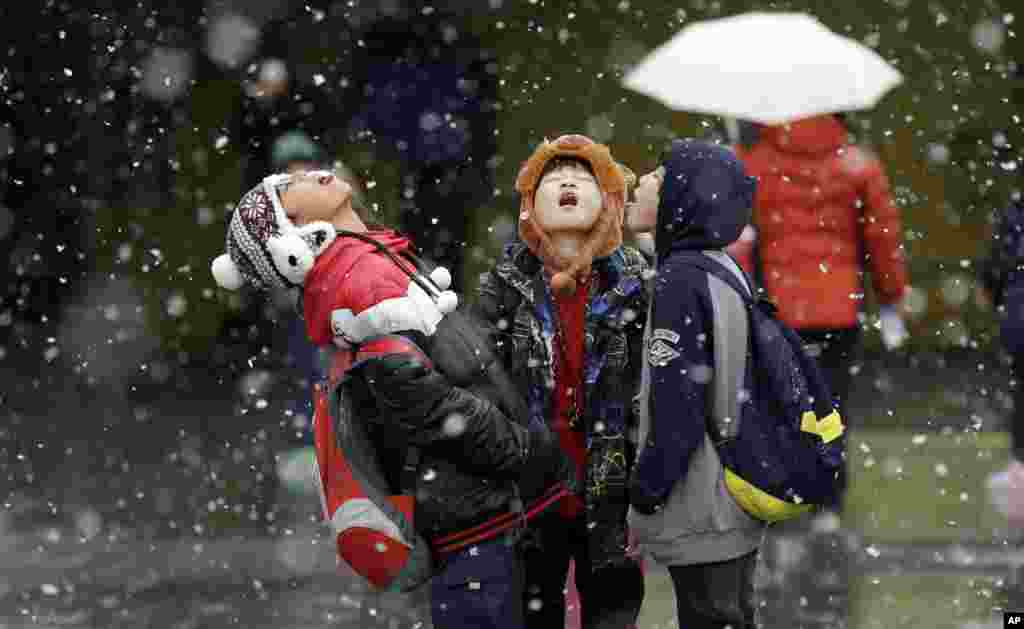 Students play in the snow in Seoul, South Korea, Nov. 27, 2013. 