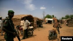 FILE - A policeman stands guard near the gold mining site in Anka, Zamfara, Nigeria.