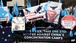 FILE - Uighurs and their supporters rally across the street from United Nations headquarters in New York, Thursday, March 15, 2018. Members of the Uighur Muslim ethnic group held demonstrations in cities around the world on Thursday to protest a sweeping Chinese surveillance and security campaign that has sent thousands of their people into detention and political indoctrination centers. (AP Photo/Seth Wenig) Uighurs and their supporters rally across the street from United Nations headquarters in New York, March 15, 2018, to protest a sweeping Chinese surveillance and security campaign that has sent thousands of their people into detention and political indoctrination centers.