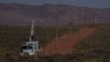 A crew with the Navajo Tribal Utility Authority installs power poles, Oct. 9, 2024, on the Navajo Nation in Halchita, Utah. 