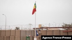 The Malian flag is hoisted during the handover ceremony of the Barkhane military base from the French to the Malian army in Timbuktu, on Dec. 14, 2021. 