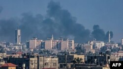 A picture taken from Rafah shows smoke billowing over Khan Yunis in the southern Gaza Strip during Israeli bombardment on December 30, 2023, as battles between the Palestinian Hamas movement and Israel continue. (Photo by AFP)