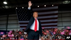 President Donald Trump arrives to speak at a campaign rally, Nov. 4, 2018, in Macon, Ga. 