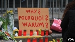 A placard outside one of the entrances to the Maelbeek metro station asks ‘why’ while other writing expresses calls for both peace and anger in Brussels, Belgium, March 24, 2016. (H. Murdock/VOA)