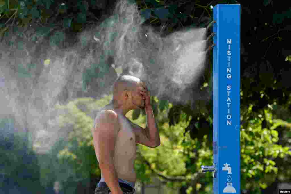 A man cools off at a misting station during the scorching weather of a heatwave in Vancouver, British Columbia, Canada, June 27, 2021.