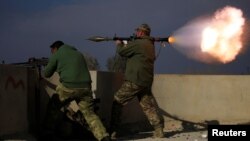 A member of Iraqi rapid response forces fires a rocket launcher during a battle with Islamic State militants in the district of Yarimja in southern Mosul, Iraq, Jan. 18, 2017.