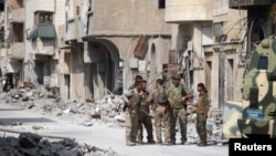 16일 시리아 락까에서 시리아민주군, SDF 대원들이 전쟁으로 파괴된 시가지를 순찰하고 있다.