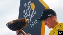 2016 Tour de France winner Chris Froome of Britain celebrates on the podium after the twenty-first and last stage of the Tour de France cycling race in Paris, France, Sunday, July 24, 2016. 