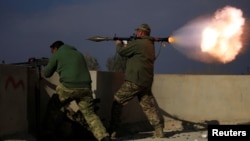 Un combattant des forces de réponses rapides irakiennes lance une roquette en direction des membres de l’Etat islamique à Yarimaja, dans le sud de Mossul, Irak, 18 janvier 2017.