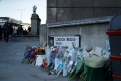 Tributes placed by the southern end of London Bridge in London, Dec. 2, 2019. London Bridge reopened to cars and pedestrians Monday, three days after a man previously convicted of terrorism offenses stabbed two people to death and injured…