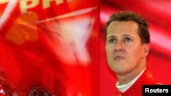 FILE - Ferrari Formula One driver Michale Schumacher watches a monitor during a free practice session for the Belgian Grand Prix in Spa-Francorchamps race circuit, Aug. 27, 2004.