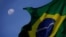 La bandera brasileña ondea con la Luna de fondo durante una protesta en Brasilia, el 24 de enero de 2021.