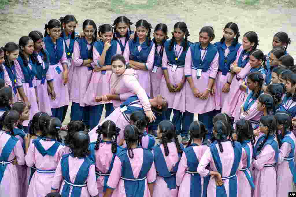Indian Muslim international karate champion, Syeda Falak (C-L), shows self-defense techniques to students at the Telangana Minorities Residential Girls School in Hyderabad.