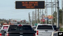 Highway signage announces the impending arrival of Hurricane Milton and the evacuations zones, Oct. 8, 2024, in Port Richey, Florida.