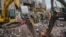 Workers and army personnel use heavy machinery as they work to clear the site and recover bodies of victims from the rubble of a garment factory building collapse in Savar near Dhaka, Bangladesh, May 6, 2013..