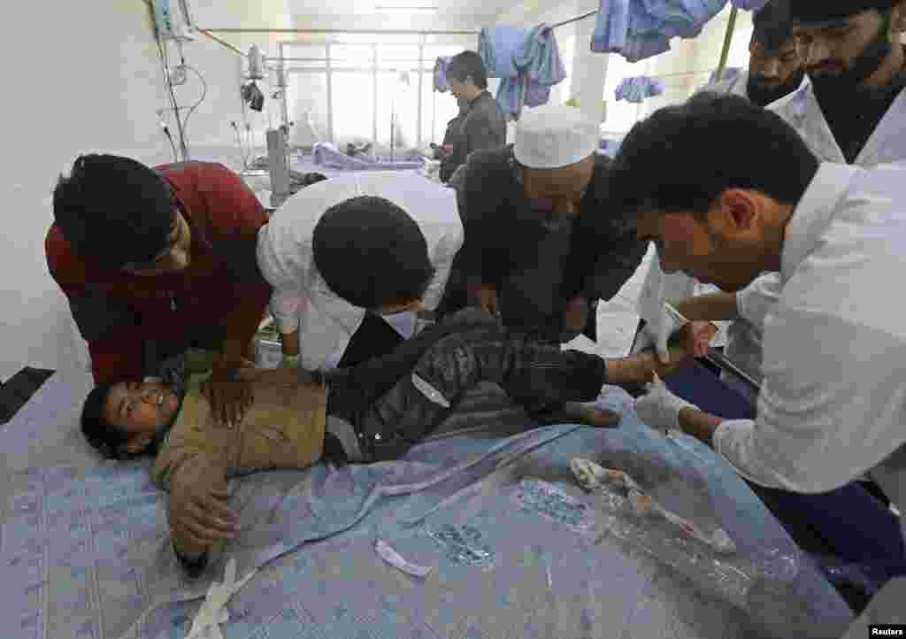 An Afghan boy receives treatment at a hospital after a suicide bomber struck a British embassy vehicle in Kabul, Nov. 27, 2014.