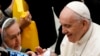 Pope Francis cheers at a newborn at the end of his weekly general audience in the Paul VI Hall at the Vatican, Dec. 1, 2021.