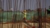 FILE - A man works at the site of the Thilawa Special Economic Zone (SEZ) project at Thilawa, Myanmar, May 8, 2015. 