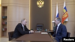 Russian President Vladimir Putin (left) meets with Foreign Minister Sergei Lavrov in Sochi, March 10, 2014.