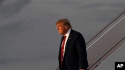 President Donald Trump walks down the steps of Air Force One at Andrews Air Force Base in Maryland, Aug. 21, 2019, after returning from Louisville, Kentucky, where he spoke to the American Veterans (AMVETS) 75th National Convention. 