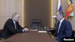 Russian President Vladimir Putin (left) meets with Foreign Minister Sergei Lavrov in Sochi, March 10, 2014.