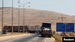 Commercial Turkish trucks wait to cross to Syria near the Cilvegozu border gate, located opposite the Syrian commercial crossing point Bab al-Hawa in Reyhanli, Hatay province, Turkey, Sept. 16, 2016. 