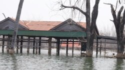 Villagers’ houses have been submerged since 2017 after the operation of Chinese-built 400-megawatt Lower Sesan 2 Dam, in Stung Treng province, on March 12, 2020. (Sun Narin/VOA Khmer)