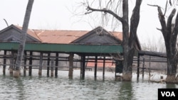 Villagers’ houses have been submerged since 2017 after the operation of Chinese-built 400-megawatt Lower Sesan 2 Dam, in Stung Treng province, on March 12, 2020. (Sun Narin/VOA Khmer)
