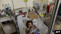 Indian patient, Aishwarya Gupta (4) lies on a bed in the dengue ward of a government hospital in New Delhi," Sept. 15, 2015. 