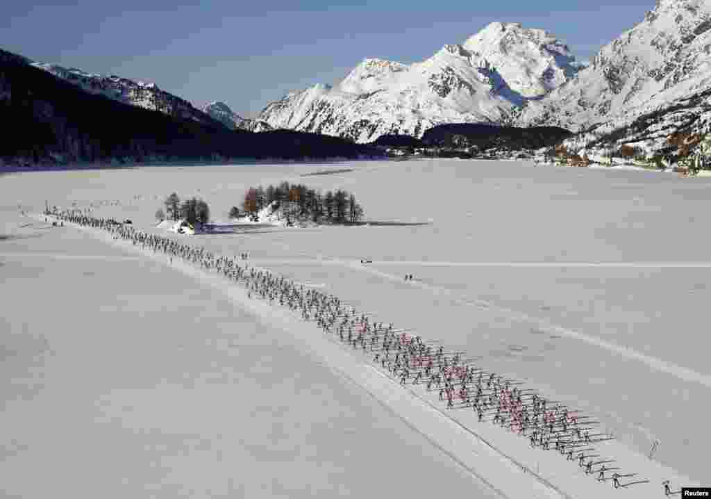 An aerial view shows cross-country skiers racing during the Engadin Ski Marathon in the village of Maloja, Switzerland. According to the organizers, more than 13,000 skiers participated in the 42 km (26 miles) race between Maloja and S-chanf near the Swiss mountain resort of St. Moritz.