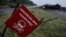 FILE - A destroyed military vehicle is seen near a landmine warning sign just outside the eastern Ukrainian town of Slaviansk, July 7, 2014. 