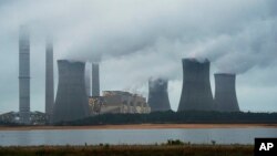 The coal-fired Plant Scherer is shown in operation early Sunday, June 1, 2014, in Juliette, Ga. The Obama administration unveiled a plan Monday to cut carbon dioxide emissions from power plants by nearly a third over the next 15 years.
