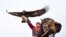 A man holding a golden eagle for an eagle hunt ride a horse during the hunting festival "Salburun" in Tuura-Suu, a small village nestled among the mountains, about 250 km. (156 miles) south-east of Bishkek, Kyrgyzstan.