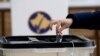 Kosovo, Pristina, A voter casts a ballot during parliamentary elections