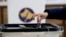 Kosovo, Pristina, A voter casts a ballot during parliamentary elections