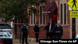 Chicago police investigate the scene of a mass shooting where more then a dozen people were shot in the Gresham neighborhood, July 21, 2020. (Credit: Tyler LaRiviere/Chicago Sun-Times)