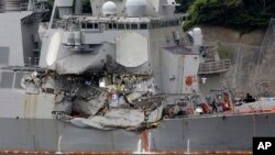 Damaged part of USS Fitzgerald is seen at the U.S. Naval base in Yokosuka, southwest of Tokyo, June 18, 2017. Navy divers found a number of sailors' bodies Sunday aboard the stricken USS Fitzgerald that collided with a container ship in the busy sea off 