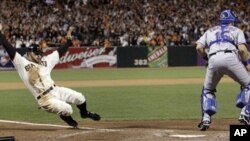 San Francisco Giants' Cody Ross slides safely home in front of Texas Rangers' Matt Treanor during the seventh inning of Game 2 of baseball's World Series Thursday, Oct. 28, 2010, in San Francisco.