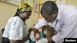 A baby receives an injection in a malaria vaccine trial in the Kenya coastal town of Kilifi.