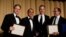 CNN's Jake Tapper, Evan Perez and Jim Sciutto, from left, accept the Merriman Smith Award from ABC News reporter Jonathan Karl at the White House Correspondents' Association dinner in Washington, April 28, 2018.