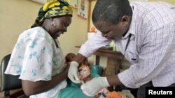 A baby receives an injection in a malaria vaccine trial in the Kenya coastal town of Kilifi.