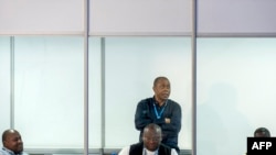 The President of the Ceni (Independent National Electoral Commission) (2R), Denis Kadima awaits the presidential election results at the Bosolo operations and results centre in Kinshasa during the day of the publication, in Kinshasa, on December 27, 2023.