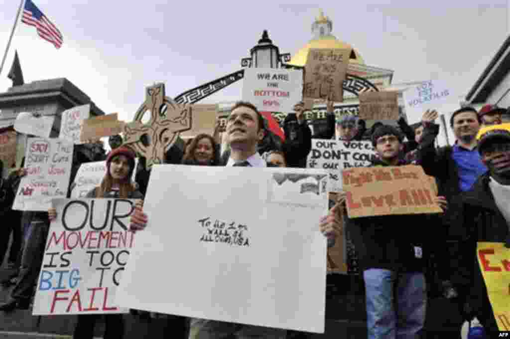 Jason Potteiger, center, leads demonstrators in a chant in front of the Statehouse, in Boston, as part of an Occupy Boston demonstration on Monday, Oct. 3, 2011. The group is part of a nationwide grassroots movement in support of the ongoing Wall Street p