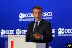 French President Emmanuel Macron delivers a speech at the OECD ministerial council meeting in Paris, May 30, 2018.