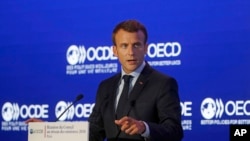 French President Emmanuel Macron delivers a speech at the OECD ministerial council meeting in Paris, May 30, 2018. 