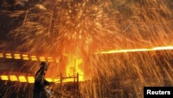 FILE - A Chinese laborer works at a steel factory in Dalian, Liaoning province.