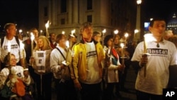 Demonstrators against the Vatican's handling of priest sex abuse cases, hold candles during a protest near St. Peter's square, Sunday, Oct. 31, 2010.