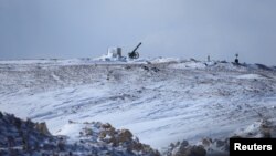 A Syrian government rocket launcher is seen covered with snow in the Damascus countryside, Syria, Jan. 28, 2017.