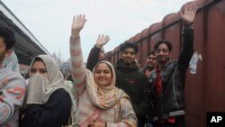 Pakistani family waves to their Indian relatives, who are leaving to return to India, after being stranded in Pakistan for a week, at Lahore Railway Station in Pakistan, March 4, 2019. 